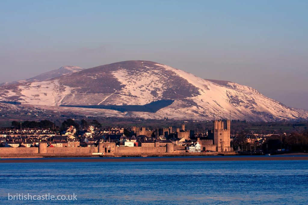 Caernarfon overlooked by a snowy Snowdon