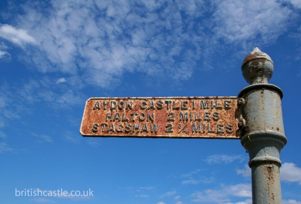Old rusty street sign to Aydon Castle
